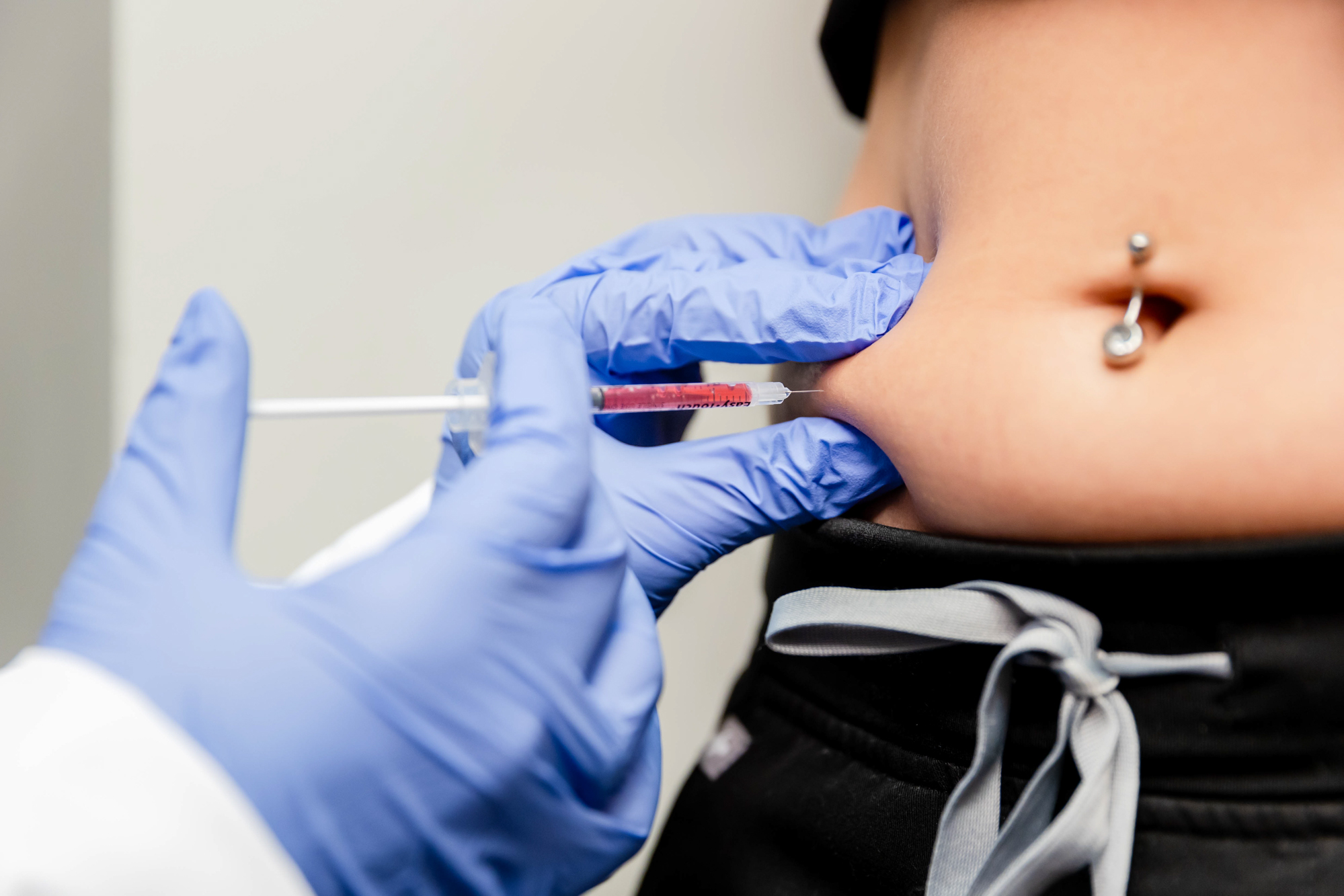 Close up of a woman's stomach as she receives a semaglutide injection at A Beautiful You Medical Spa